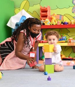 Teacher and toddlers playing with building blocks in the Kissyfur daycare