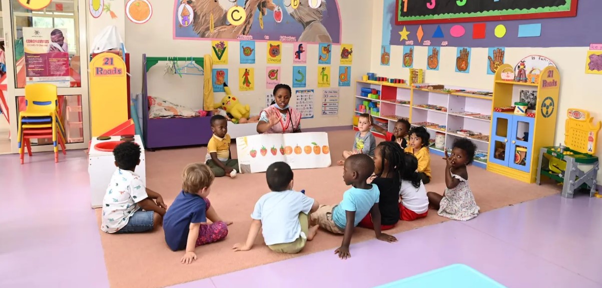 Kindergarten children sitting together for a group activity in a Kissyfur classroom